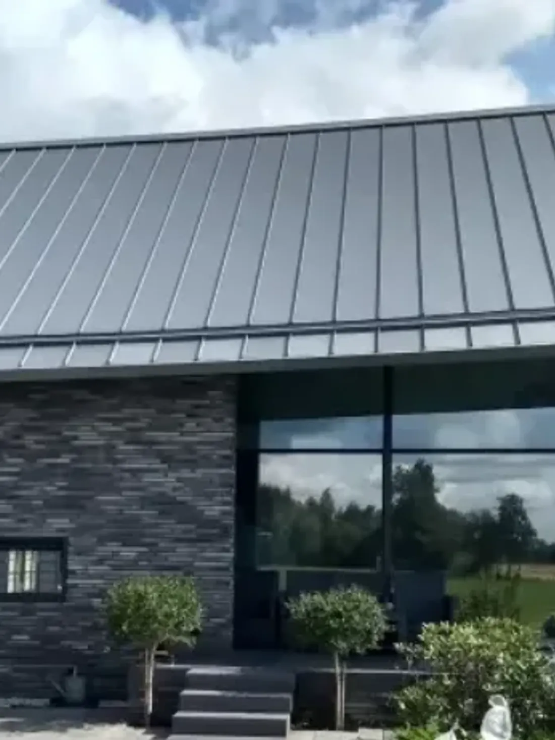 Klikfels in Slate Grey op een dakvlak boven grote glaspuien