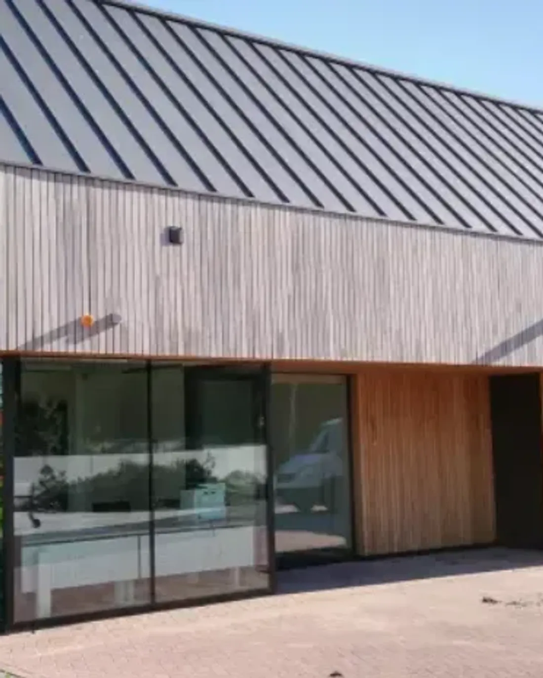 Klikfels op een bedrijfsgebouw met een lichte houten gevel